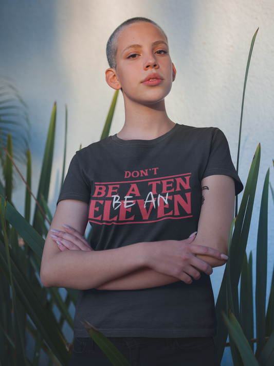 Be Eleven gothic tee featuring bold statement text and dark alternative apparel style from The Warning Chapter.Shirt reads Don't be a ten, Be an Eleven. Mock Stranger Things Font