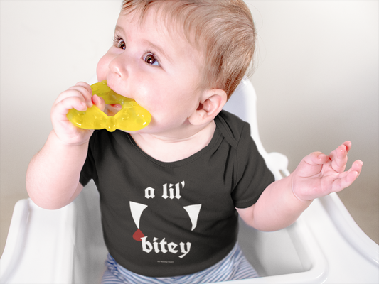 A Lil’ Bitey gothic baby onesie mockup featuring a spooky-cute vampire-inspired design for babies and tiny teethers.