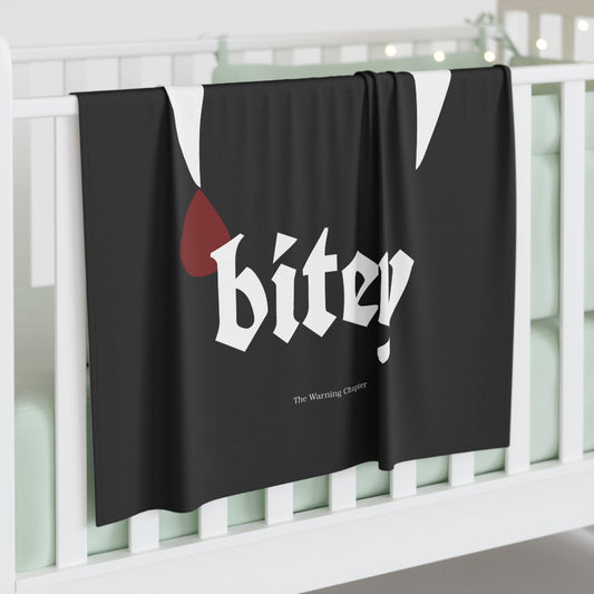 Black gothic baby blanket featuring the phrase a lil’ bitey with white vampire fangs and a red blood drop design.